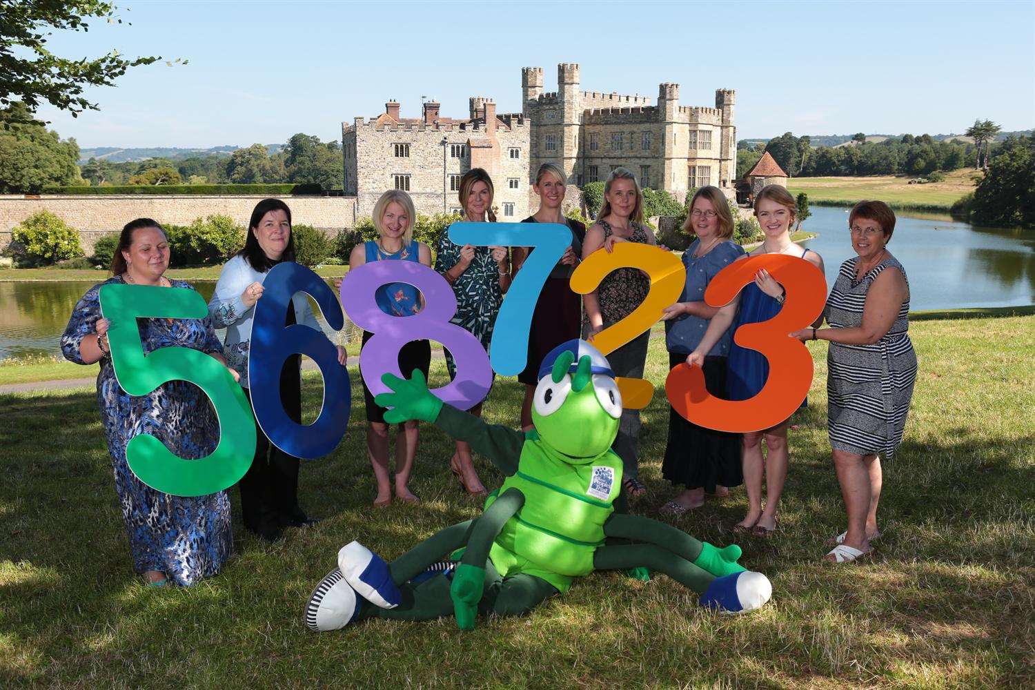 Supporters celebrate the success of Buster's Book Club literacy pilot at Leeds Castle with mascot Buster Bug