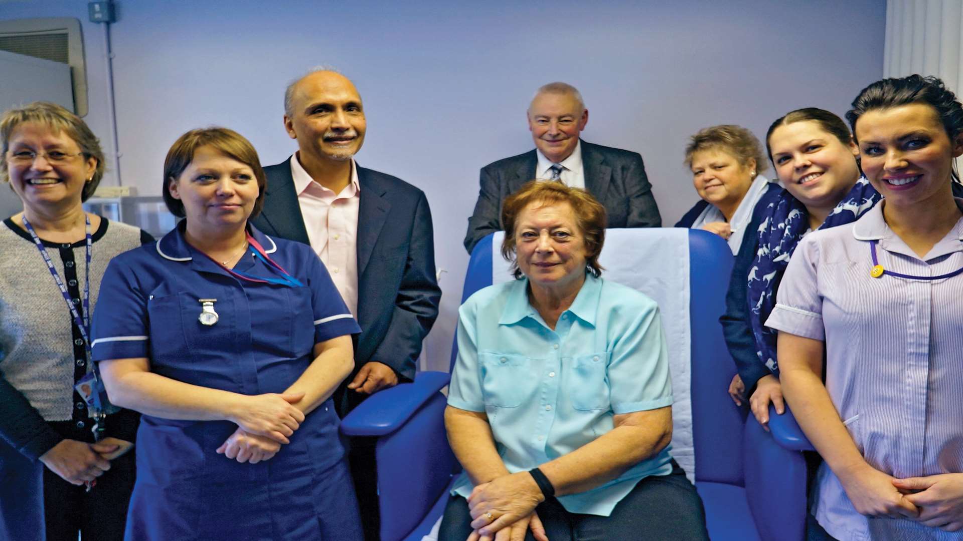 Patient Valerie Harris (seated centre) surrounded by the Wound Medicine Centre team, and husband Peter (behind the chair)