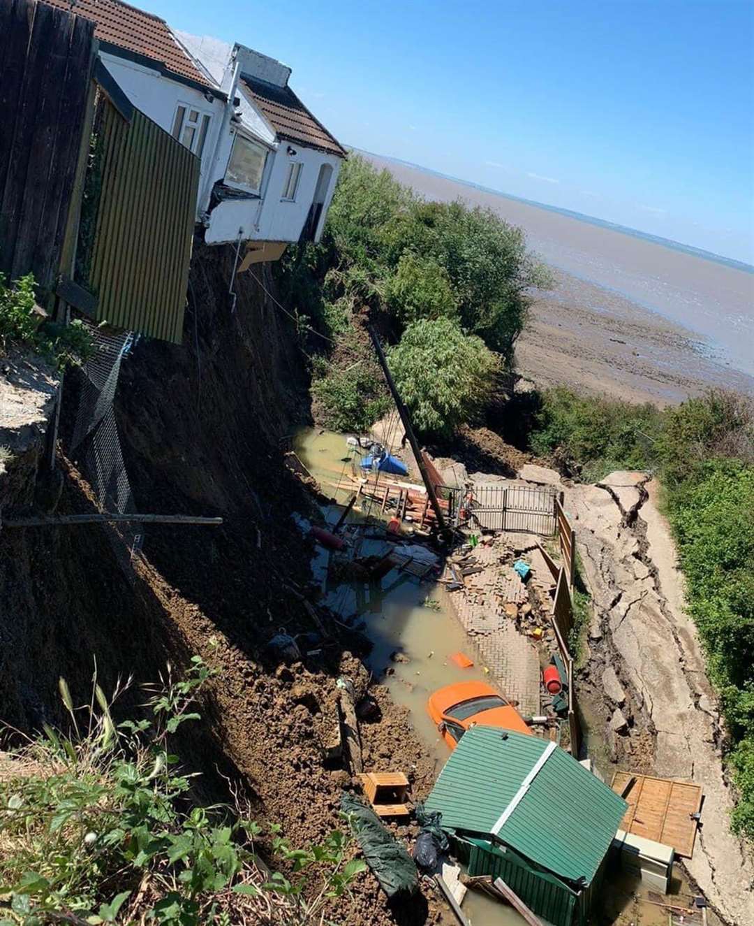 The cliff collapse has taken the home's driveway and part of the building with it Picture: Kent Fire and Rescue Service