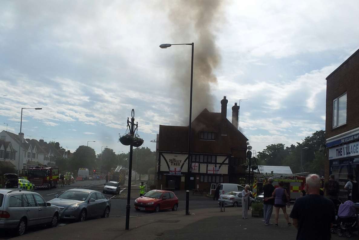 Onlookers gathered as smoke billowed from The Holly Tree pub. Picture: Trevor Parker
