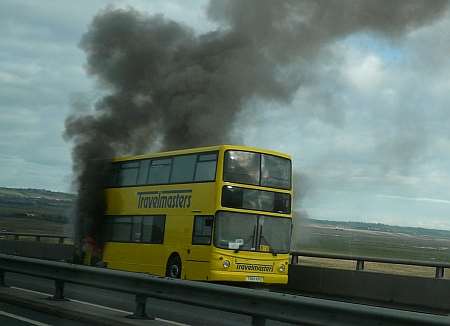 Smoke billows from the stricken double-decker bus on the Sheppey Crossing.