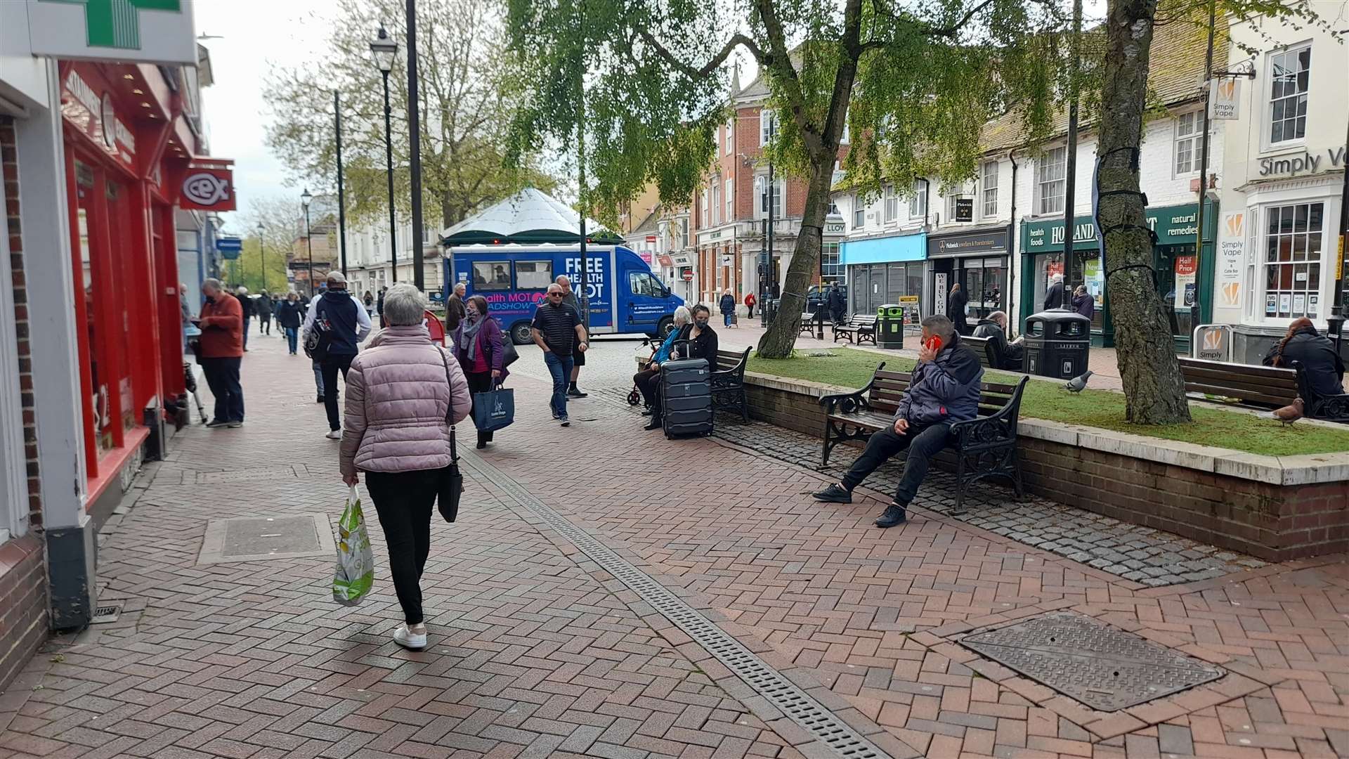 The high street is bustling with shoppers today despite the rain