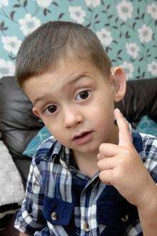 Oliver Smith, four, with his new hearing aid