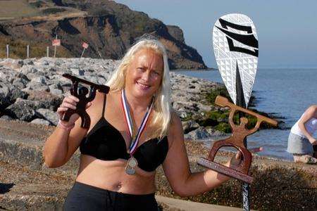 Julia Haggis Summer Sizzler Sup race series winner with her trophies.