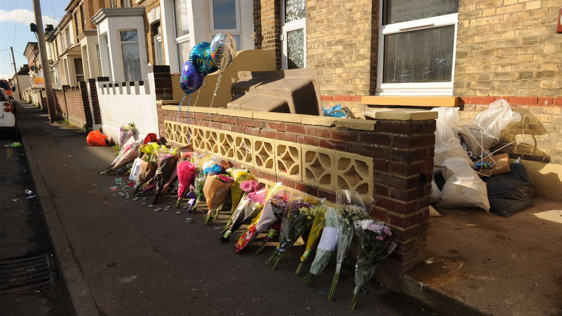 Floral tributes and balloons left at the scene