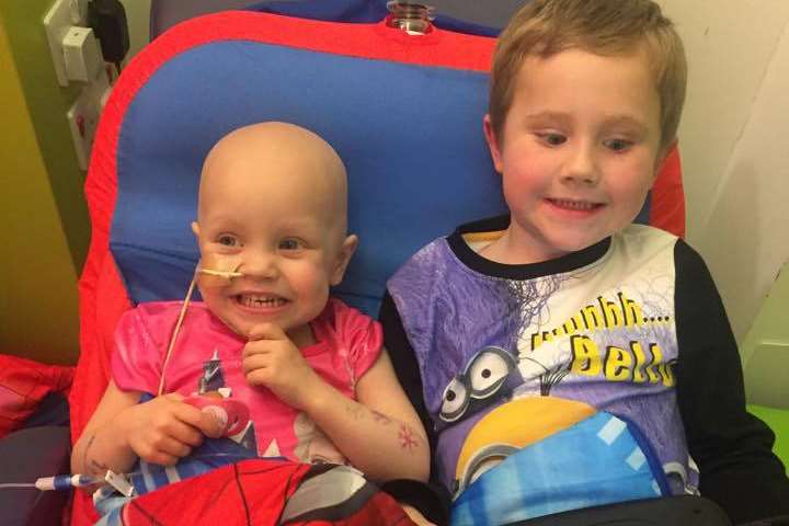 Ruby Young, two, playing her with brother Freddy, five, in hospital