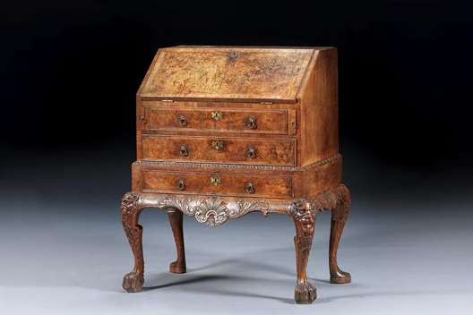 A George II carved walnut bureau