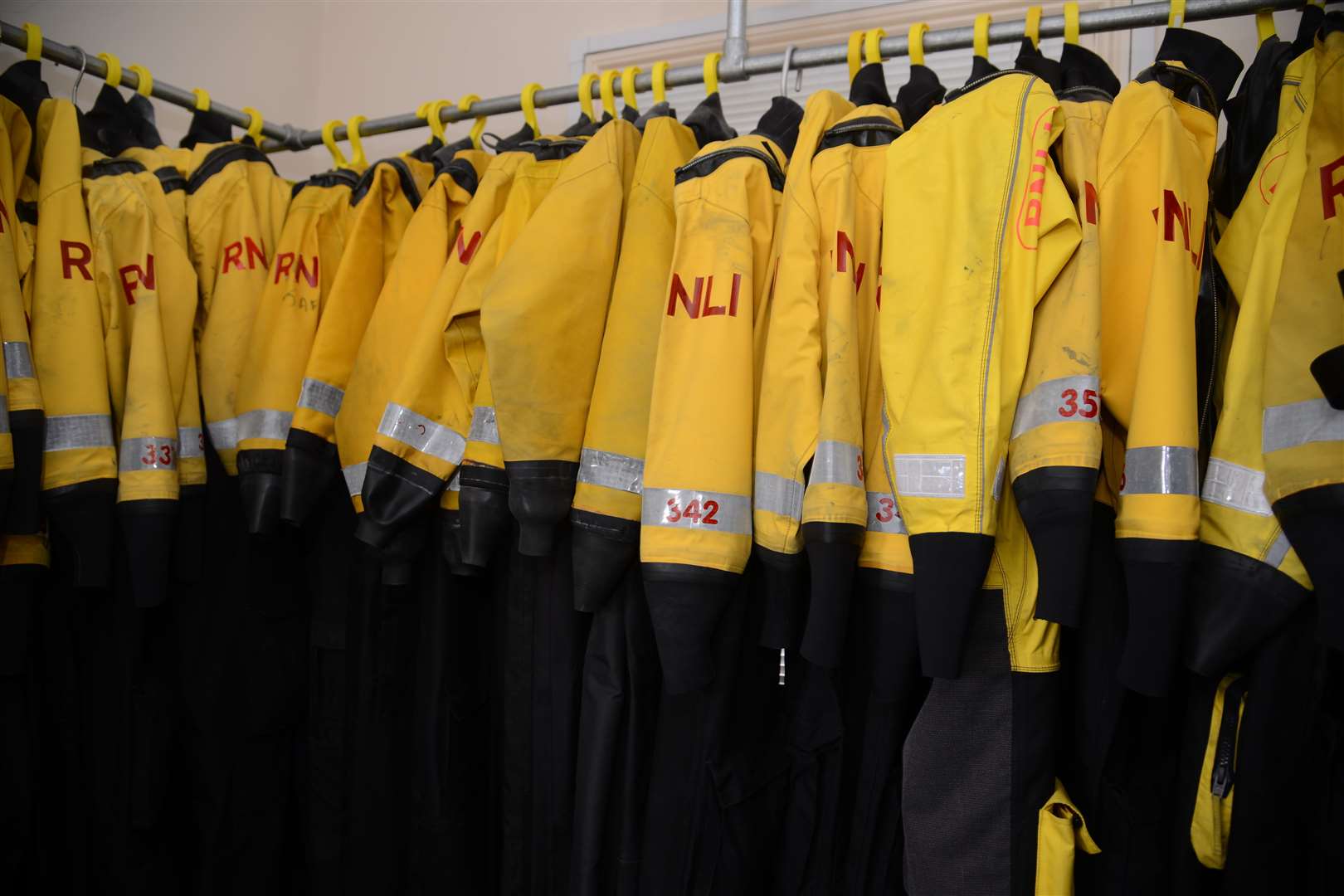 Crew members suits lined up in the locker room