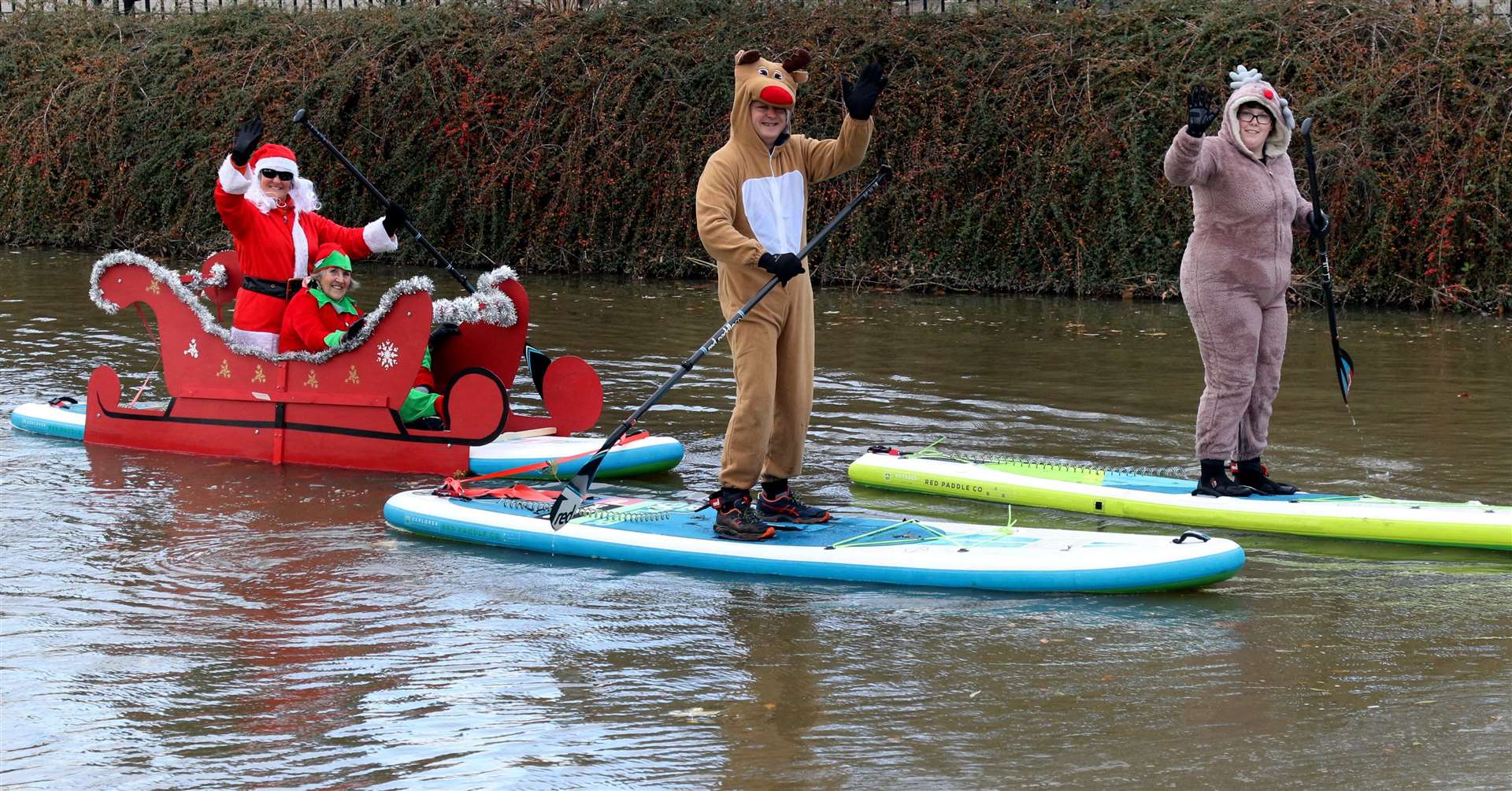 Santa paddle boarders on the river at Tonbridge