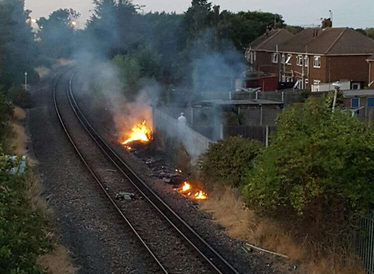 A spark from a passing train reportedly caused a grass fire behind properties in Queensway, Sheerness, on Friday night. Pic by Adrian Austin.