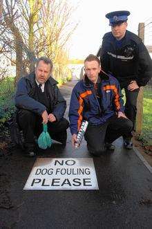 Swale council dog warden Tim Oxley, Environment Warden Daniel Bacon and PCSO Robert Holmes with the No Dog Fouling Please message in Labworth Alley, Halfway