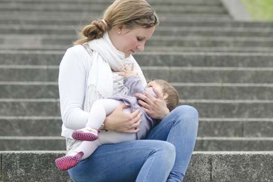 Nikki breastfeeds Florence, aged nine months, on steps