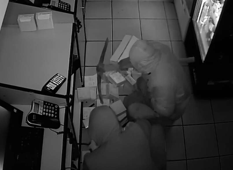 Thieves attempt to prize off the safe using a pickaxe