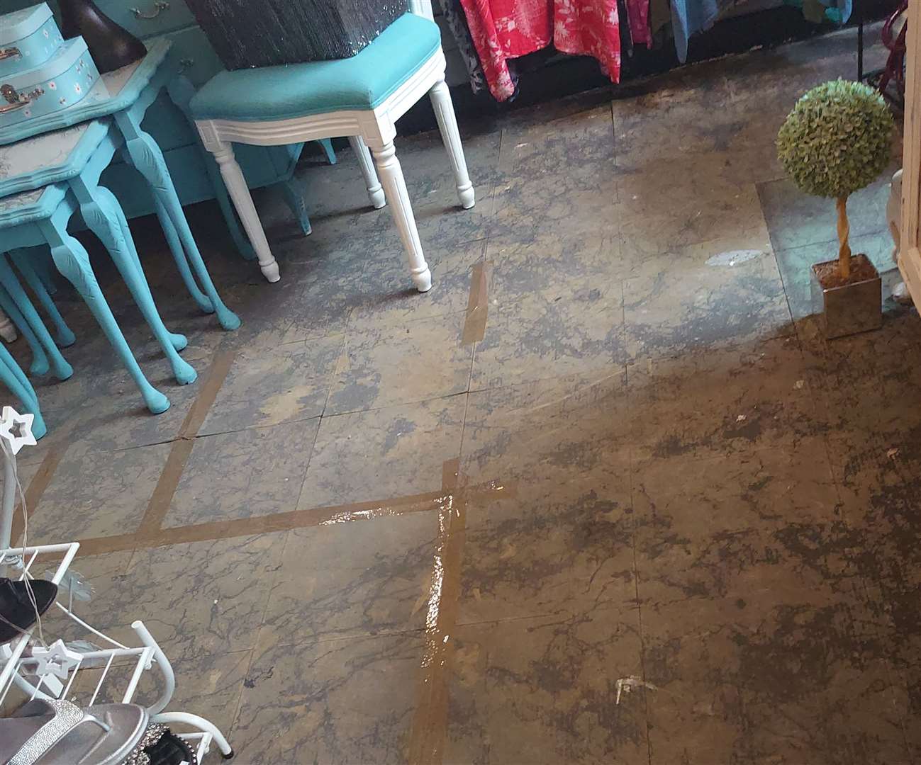 Picture shows the damaged shop floor after the carpet had to be removed