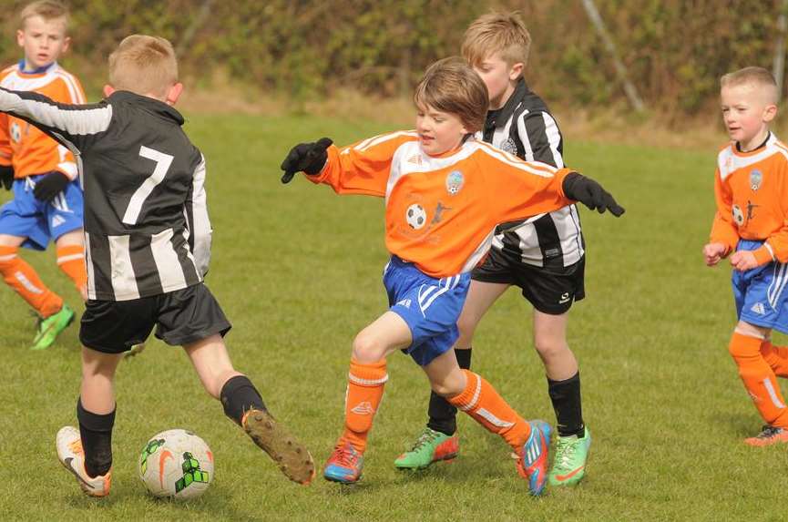 Real 60 Pumas (stripes) and Cuxton under-8s contest possession Picture: Steve Crispe