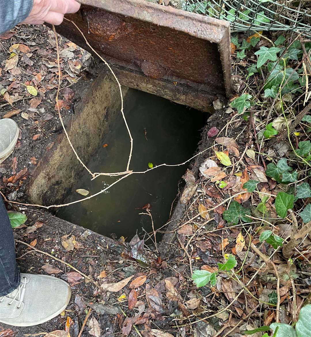 This manhole in Steve Tragner's front garden in Whitstable has been overflowing with sewage following the installation of a telegraph pole