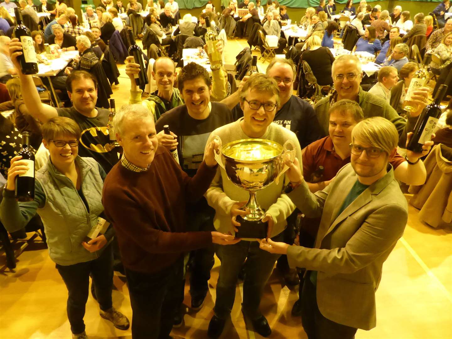 The winning Stargating across the Quizziverse team receive the KM Big Charity Quiz trophy from sponsors David Fifield of Hallett and Co and Jamie Wynn of Specsavers