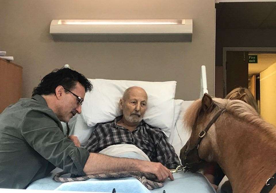 A therapy pony nuzzles up to 81-year-old Alan at the Heart of Kent Hospice watched by TV Supervet Professor Noel Fitzpatrick. The encounter was featured on Channel 4's Animal Rescue Live (15365556)