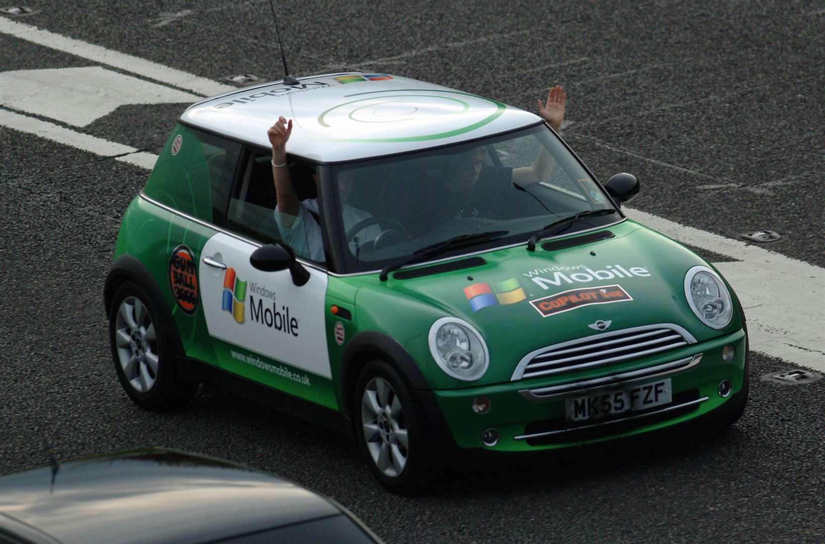 A BMW MINI crew wave to the crowd in 2006