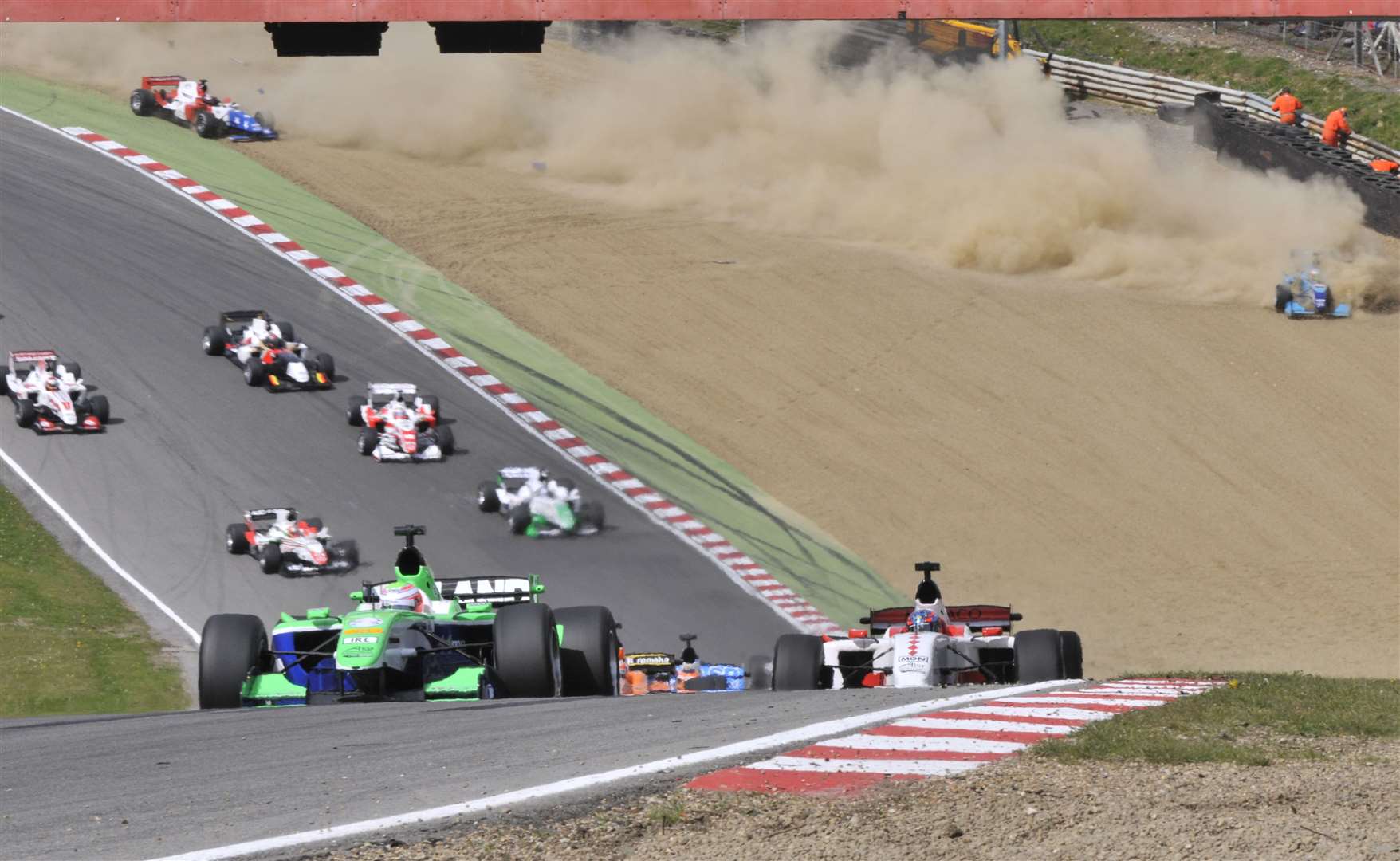 Ireland's Adam Carroll leads the A1GP feature race at Brands Hatch in May 2009, while India's Narain Karthikeyan hits the gravel at Paddock Hill Bend in the background. Picture: Andy Payton