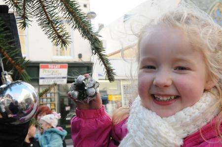 Grace Walker, five, lends a hand with the decorations