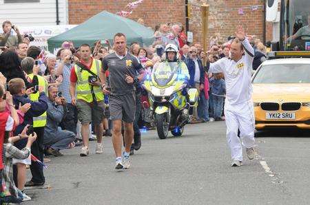 Ben Afforselles, from Hamstreet, ran the second leg of the relay through the village. Picture: Wayne McCabe