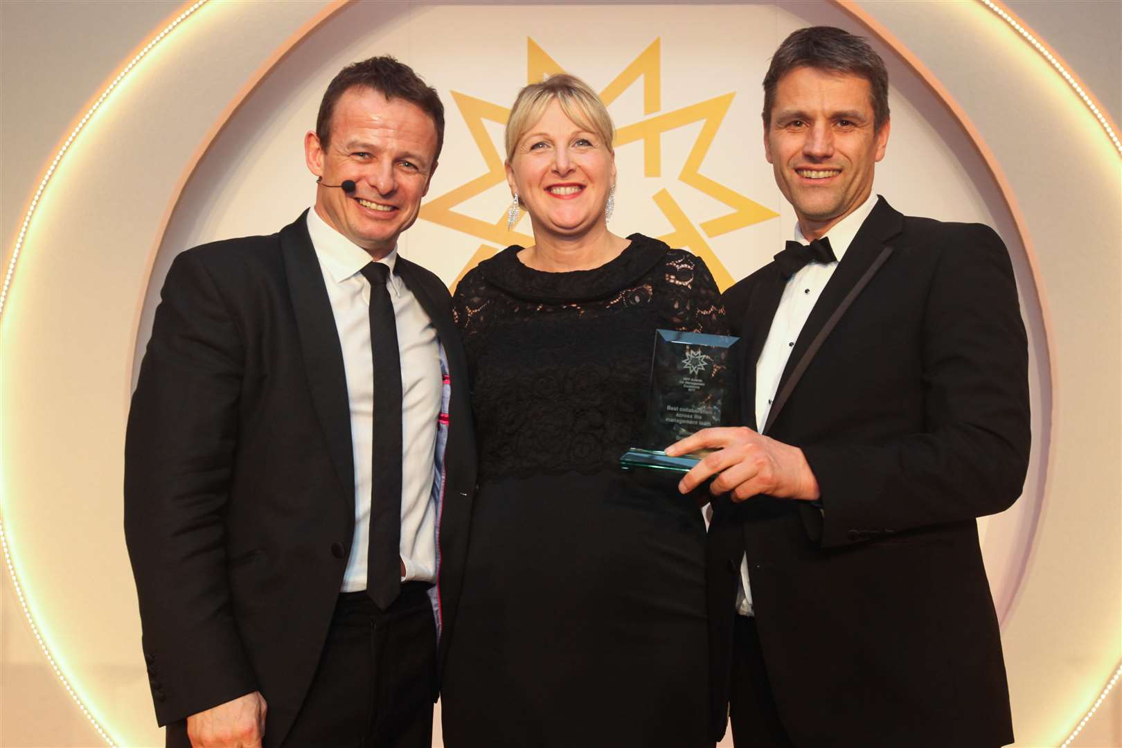 Brachers managing partner Jo Worby collects the award from rugby star Austin Healey, left, and Ben Kent of Meridian West