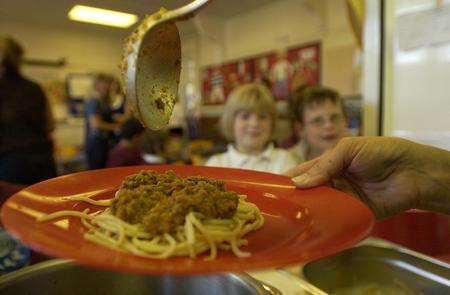School pupils about to be served spaghetti made using minced beef