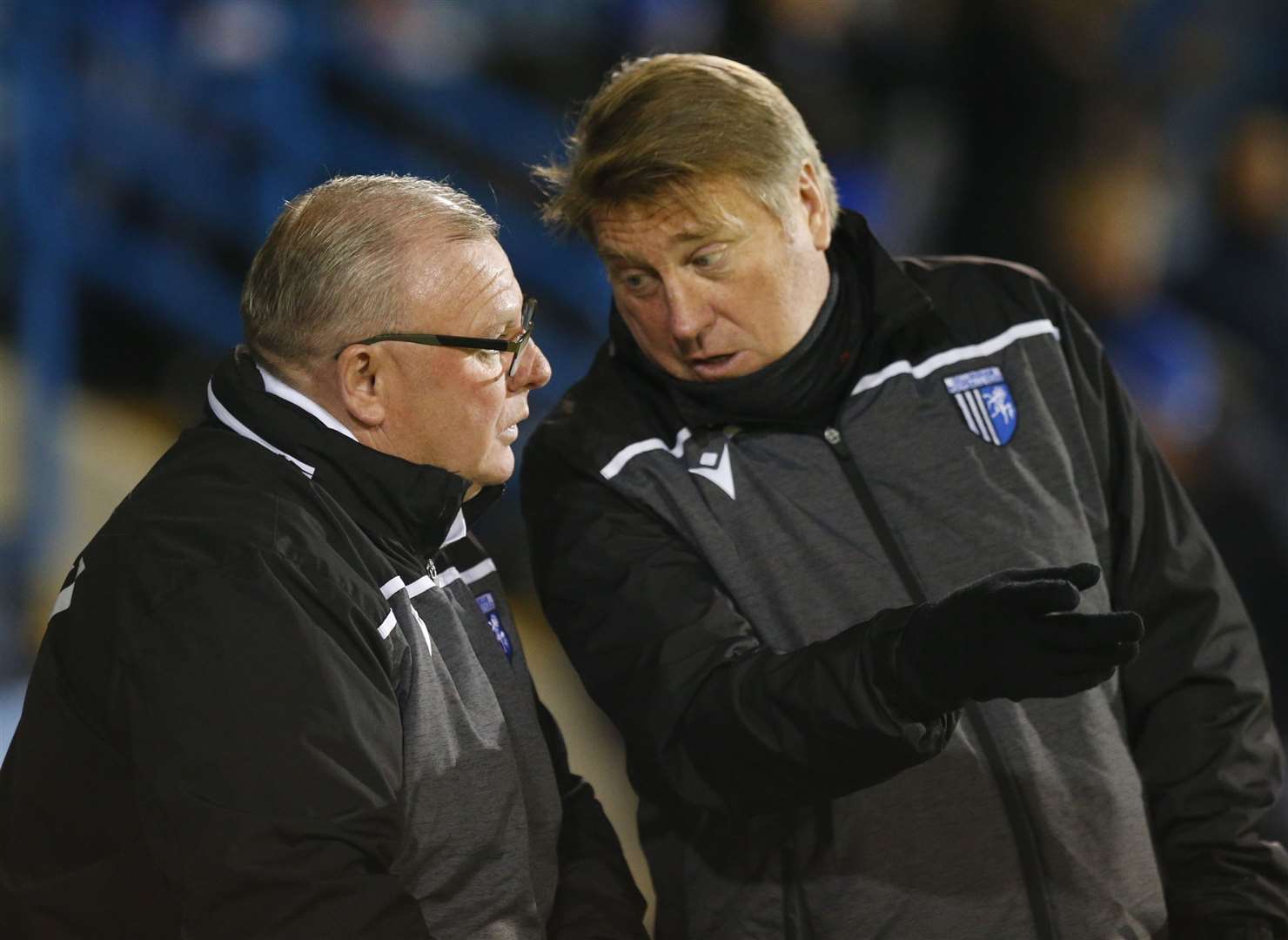 Gills boss Steve Evans and assistant manager Paul Raynor talk tactics. Picture: Andy Jones