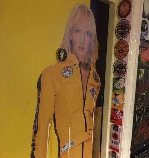Uma Thurman in all her Kill Bill glory graces the door of the ladies