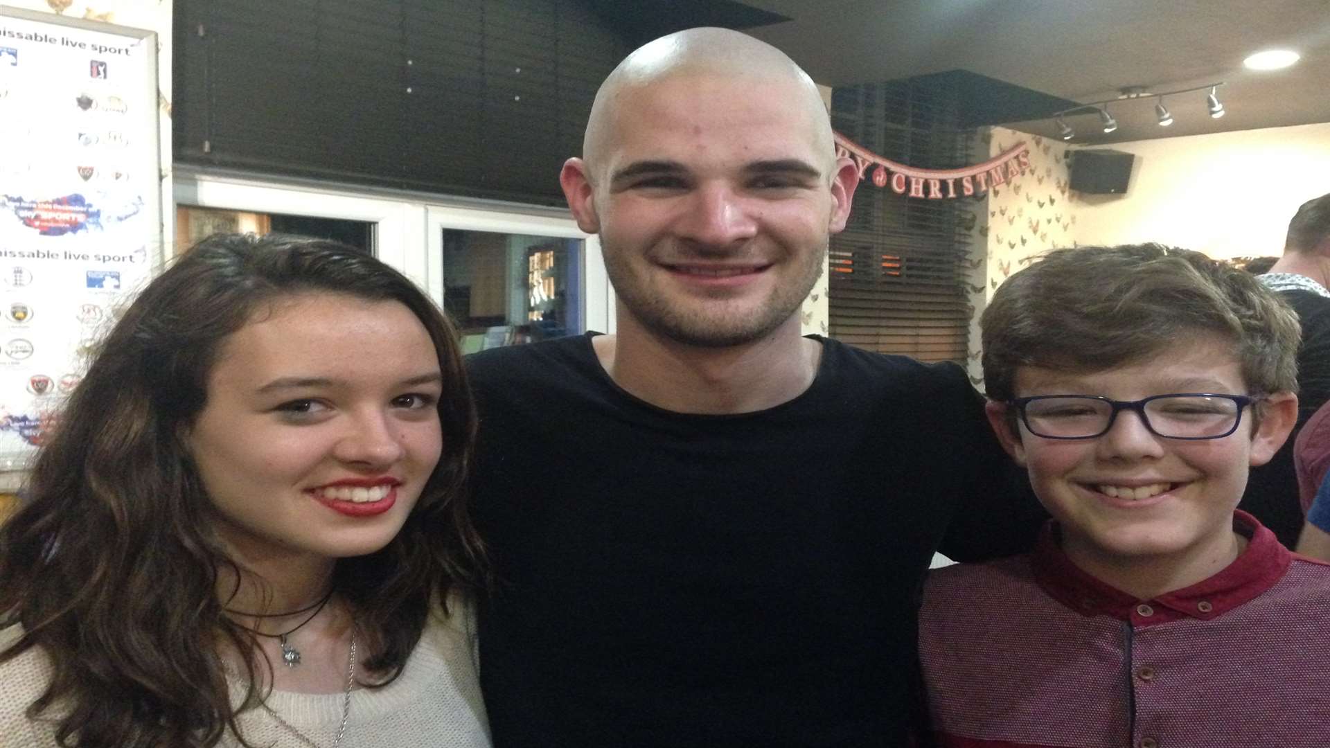 Jon Harris after the head shave with siblings Sarah and Daniel Colyer