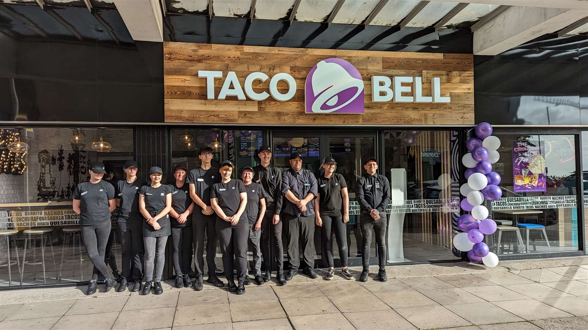 Taco Bell staff outside the new branch in West Terrace, Folkestone, opposite the town's long-established McDonald's
