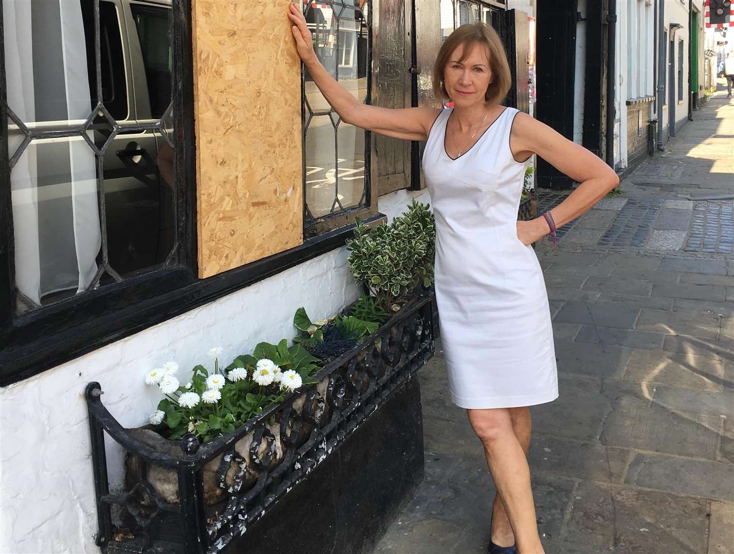 Sandie de Rougemont beside the most recent smashed window