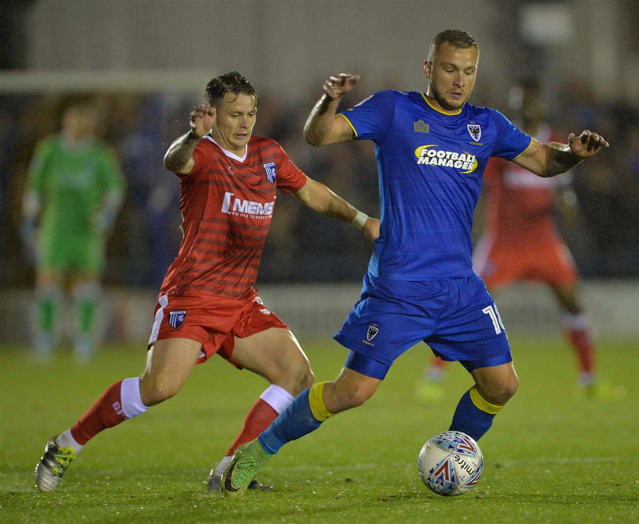 Mark Byrne challenges Gills' new signing Dean Parrett during a game against Wimbledon in September 2017