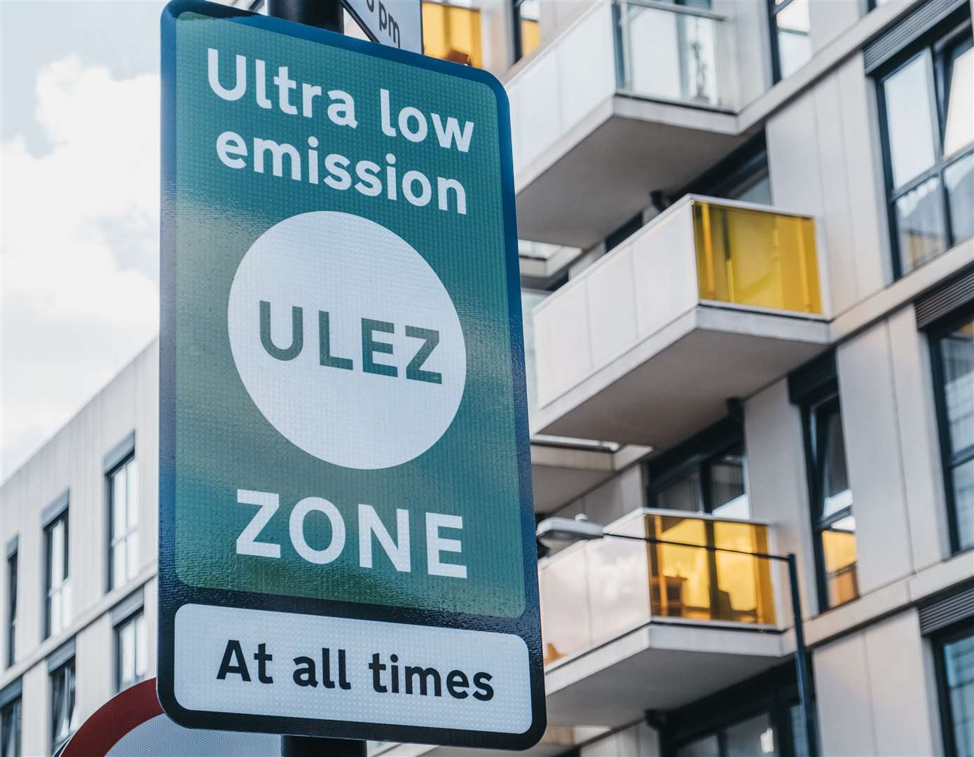 Signs indicating Ultra Low Emission Zone (ULEZ) on a street in London, UK.