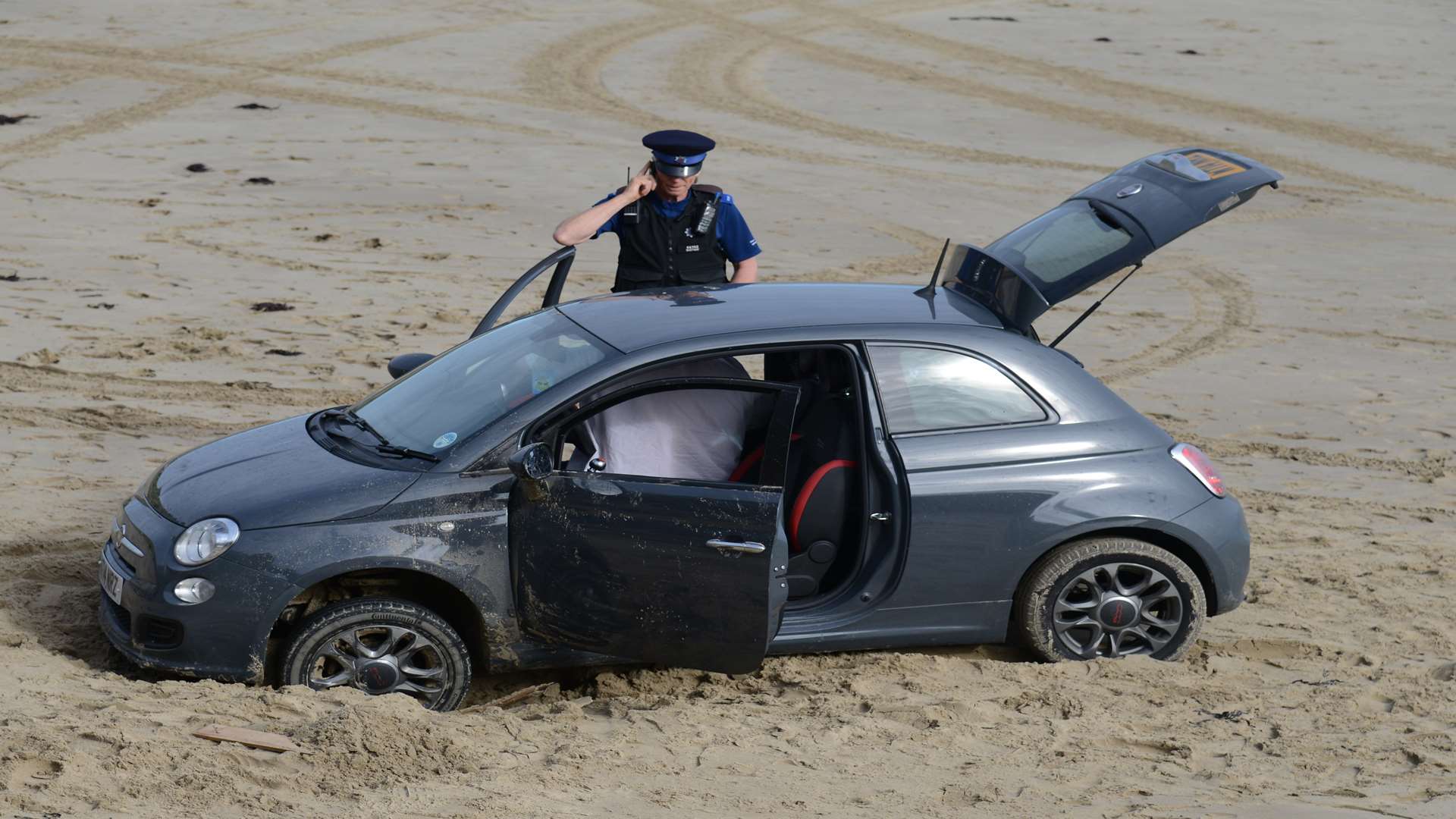 A car stuck on Sunny Sands beach in Folkestone. Picture: Gary Browne