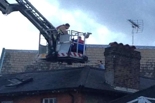 A police negotiator talks to the man on the roof. Picture: Jack Lambert
