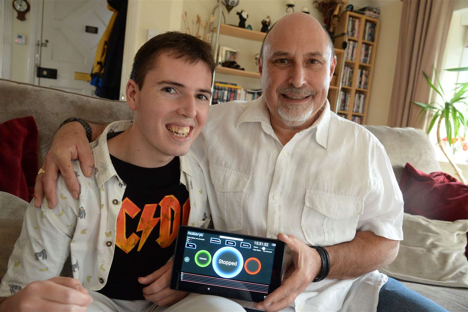 Tom Perry and his father Adrian with the updated version of PulseGuard which helps to monitor epileptic fits. Picture: Chris Davey