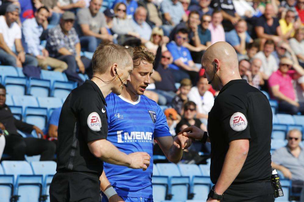 Lee Martin (Gillingham) hands a coin to the ref as it delays him taking a corner