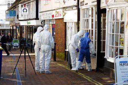 Forensic officers outside the Esack hair salon in Ashford