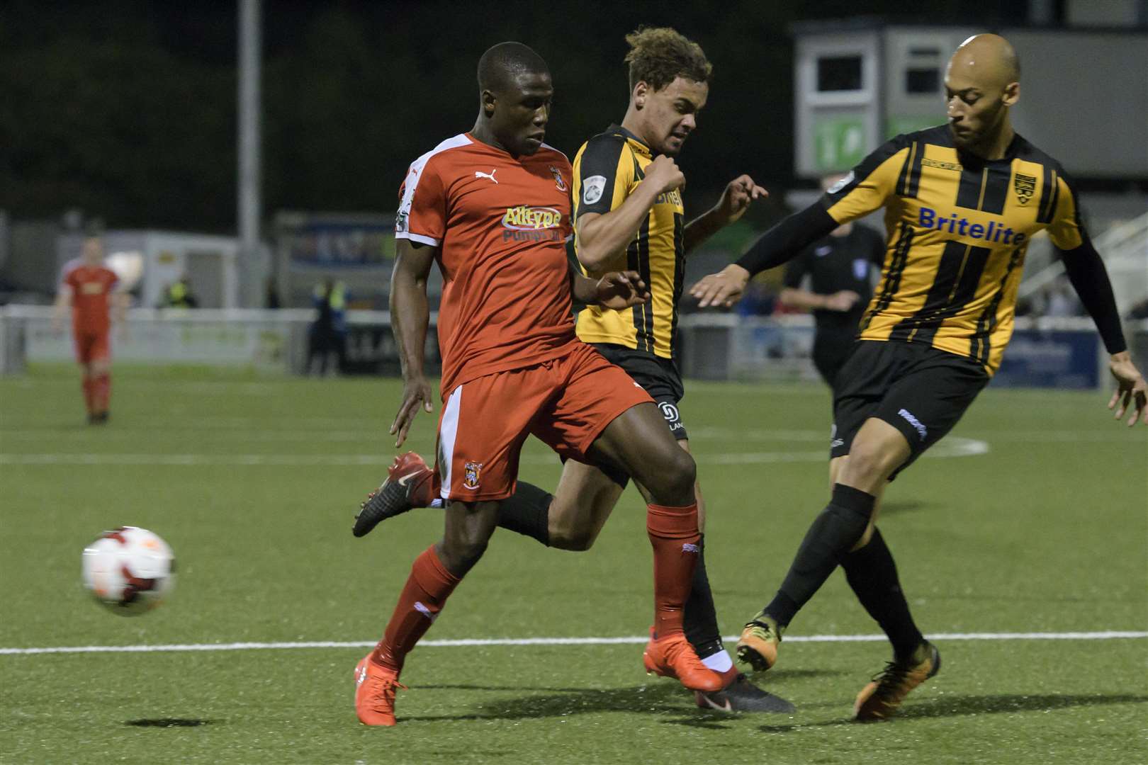Ade Yusuff finds his run blocked by Maidstone's Michael Phillips and Alex Finney Picture: Andy Payton