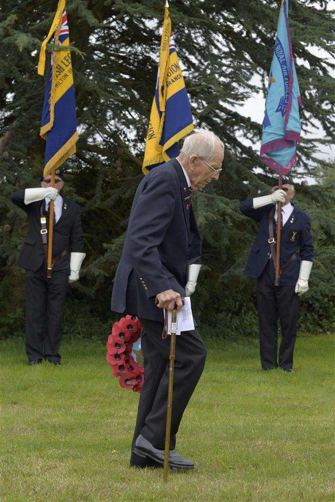 Veteran Alf Moore walks with his wreath to the memorial