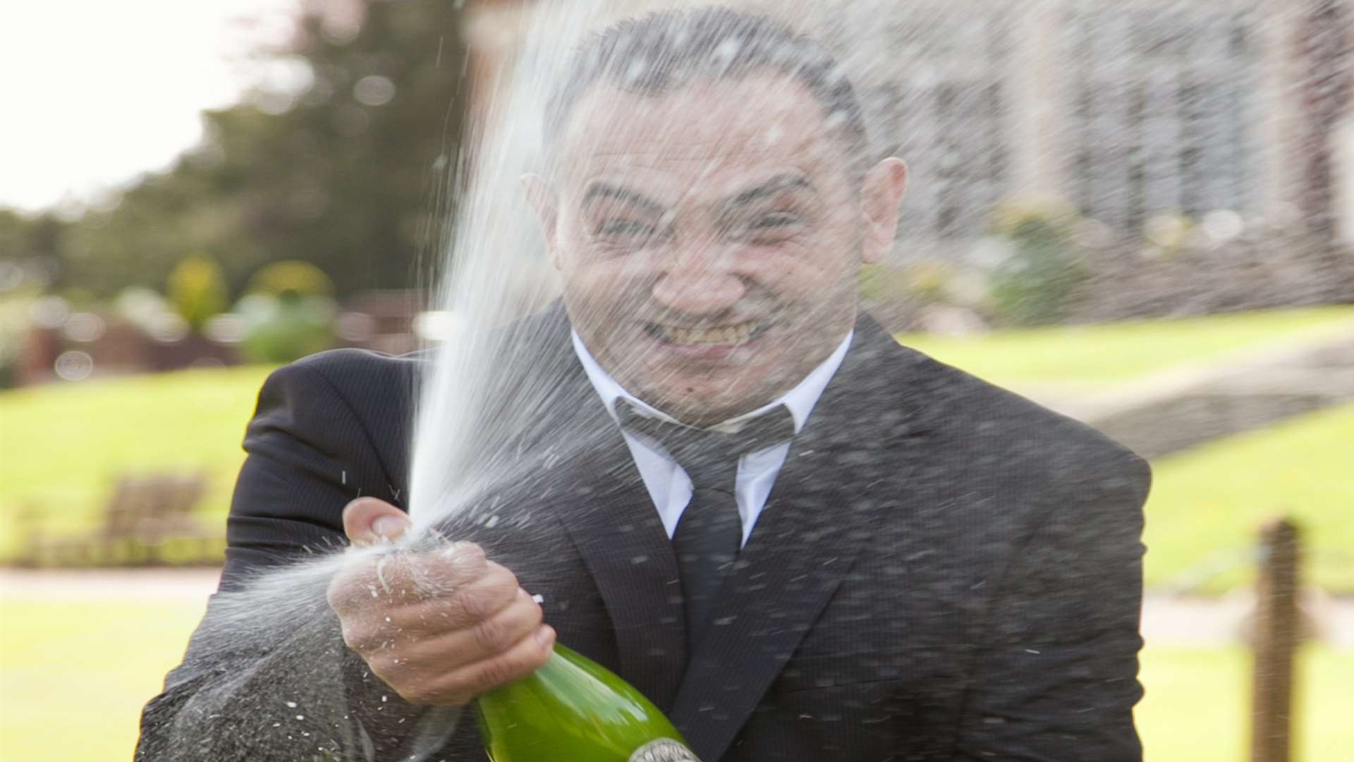 Stefan Krok pops open a bottle of bubbly to celebrate his £300,000 lottery scratch card win