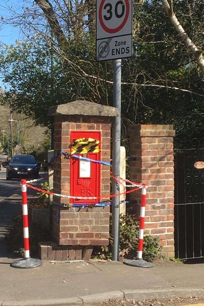The damaged postbox with its concrete hat