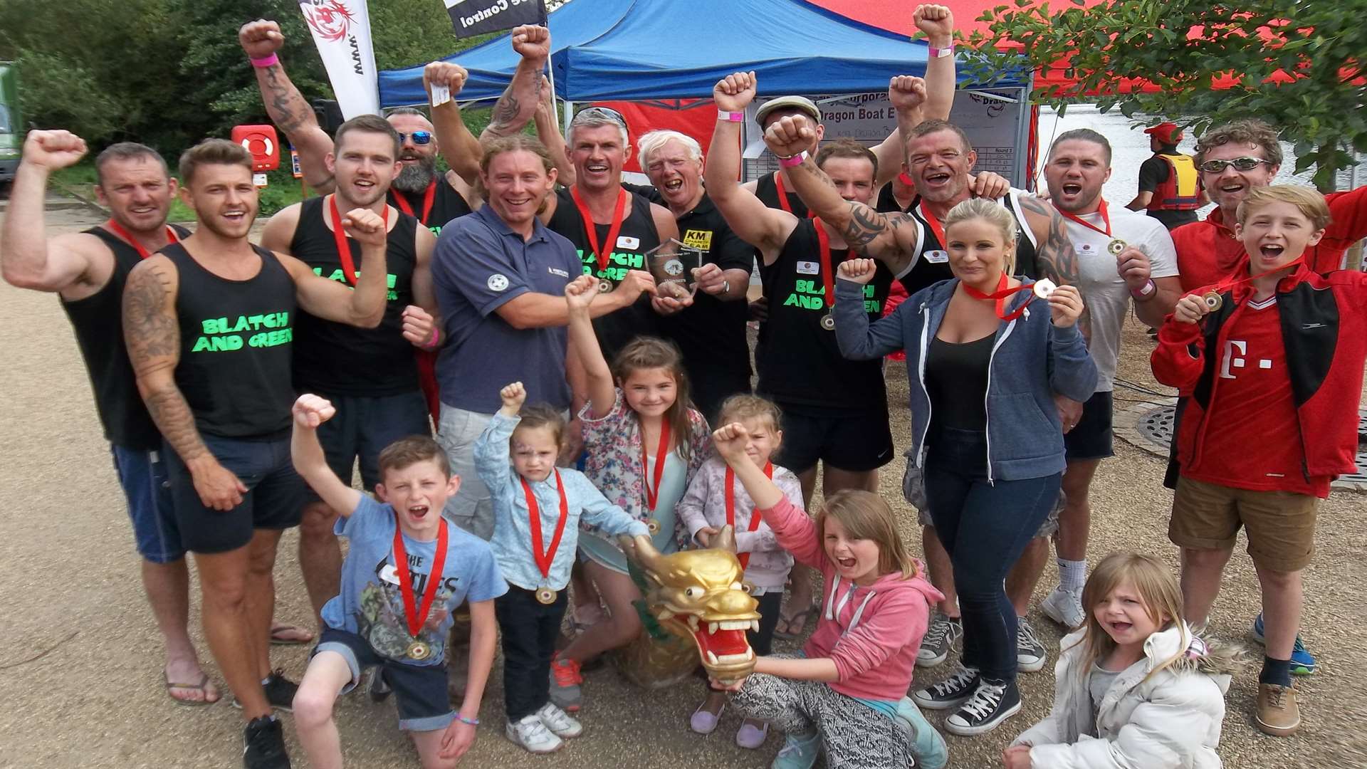 Blatch and Green received the winners trophy and medals in the grand final at the KM Dragon Boat Race from Stuart Clarke of Mote Park Water Sports Centre and Martin Vye, chairman of the KM Charity Team. Blatch and Green from Whitstable raised funds for Cancer Research UK