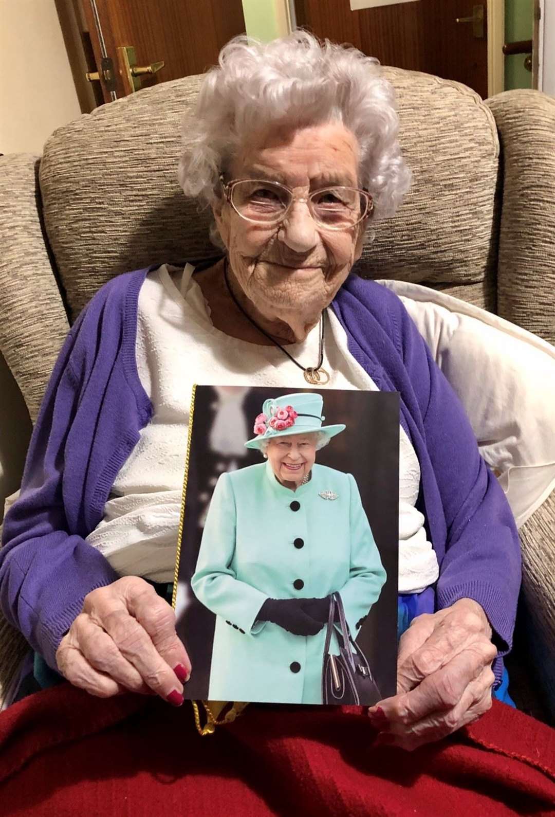 100-year-old Florence (Floss) May Cork with her card from the Queen