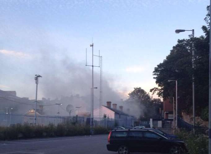 Smoke pours from the burning newsagent shop at Maidstone East train station Picture: @chris_c88