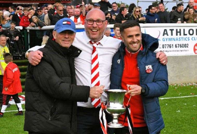Matt Smith celebrating the SCEFL Premier Division title with Ernie Batten and former assistant Marcel Nimani