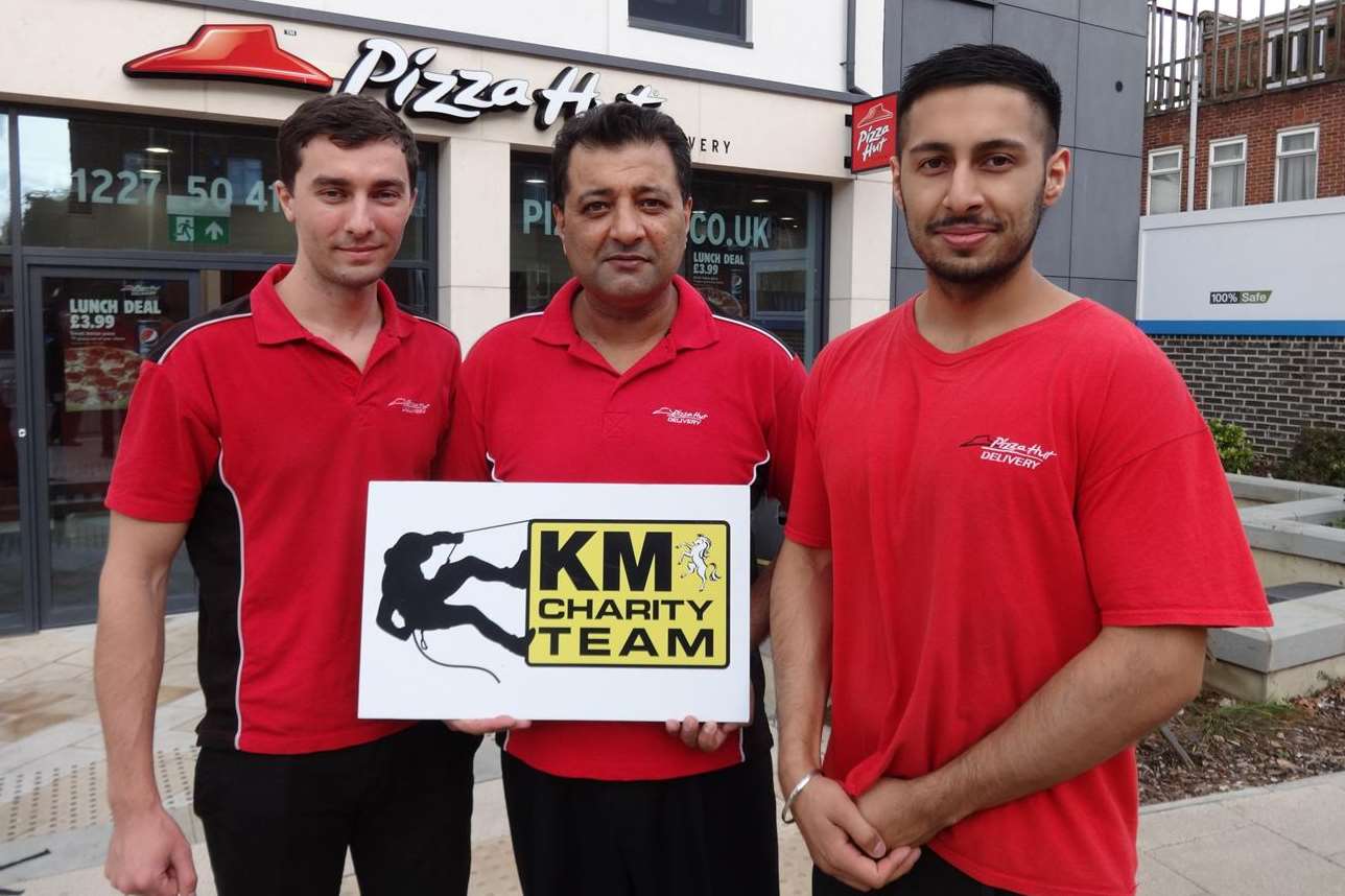 (From left) Cezar Loghin, Joe Singh Johal (franchisee) and Manil Johal (manager) from Pizza Hut, Canterbury, celebrate the restaurant's support of the KM Abseil Challenge which is being staged at Premier Inn on November 1.