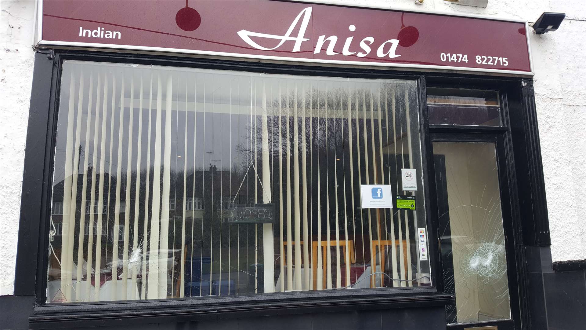 Damage to the window and front door of Anisa Indian Cuisine